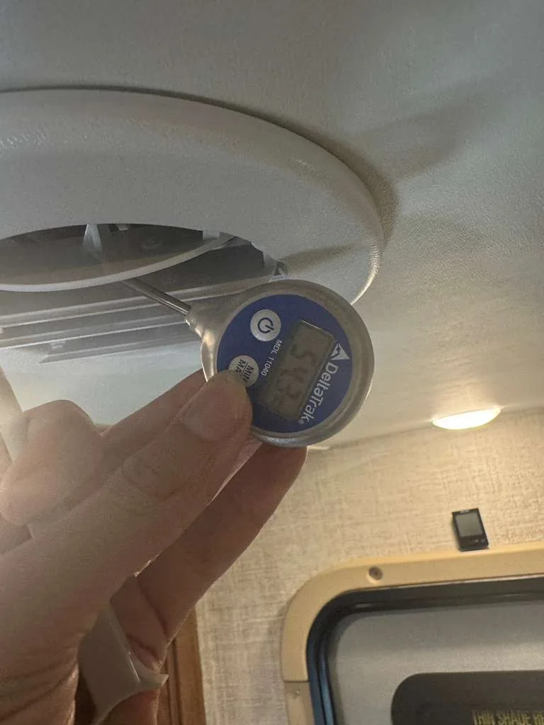 Checking AC vent temperature during an RV AC repair