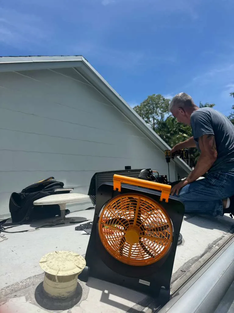 Technician mounting solar panels on an RV roof in Palm City FL